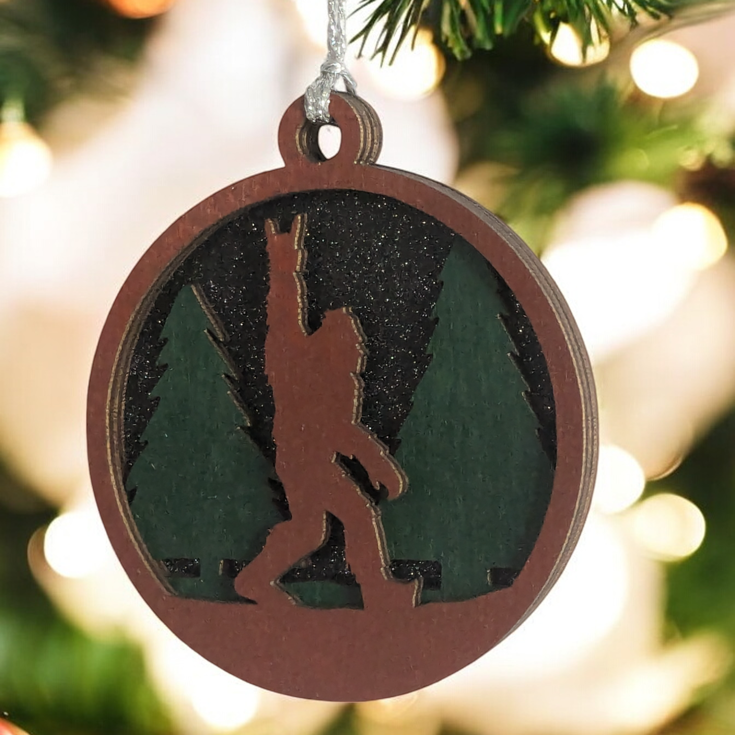 Unique 3" Wooden Bigfoot Ornament - 3-Layer Laser Cut, Sasquatch Throwing Rock Horns, Glitter Night Sky, Oregon-Made