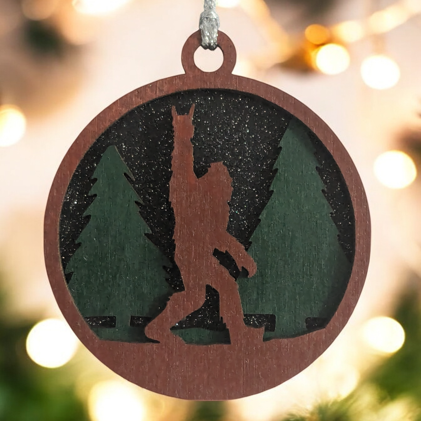 Unique 3" Wooden Bigfoot Ornament - 3-Layer Laser Cut, Sasquatch Throwing Rock Horns, Glitter Night Sky, Oregon-Made